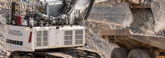 Excavator loading a haul truck at a mine site