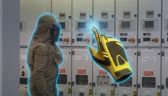 An apprentice rehearsing electrical isolation in VR with an AR glove overlay