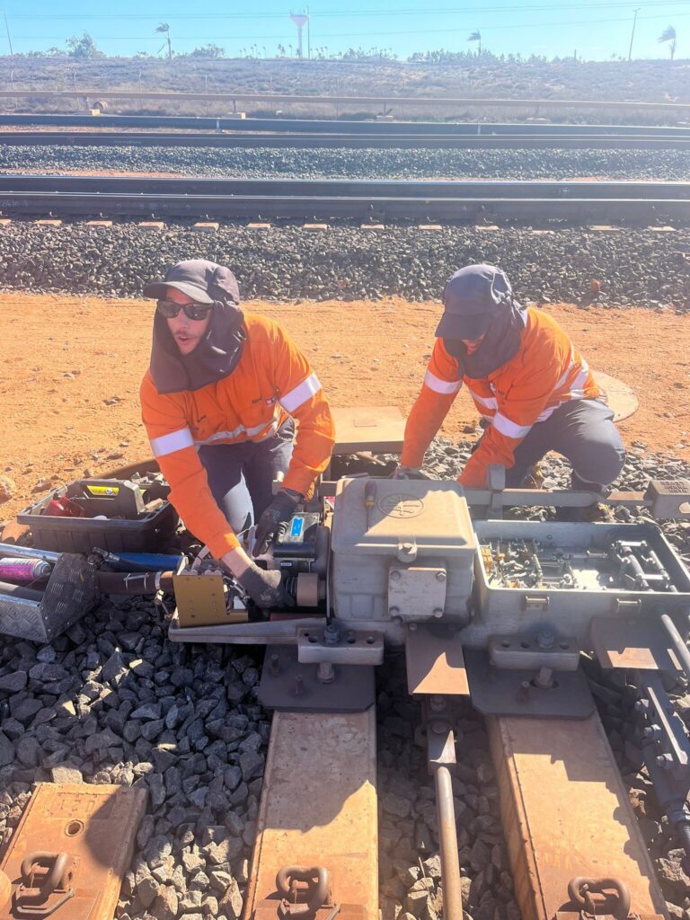 Rail signalling technicians working on track in WA